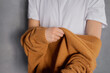 © Olga Kozicka/Stocksy - Putting On Sweater