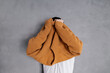 © Olga Kozicka/Stocksy - Pulling Sweater Over Head