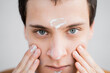 © Olga Kozicka/Stocksy - Man Hydrating Face With Cream