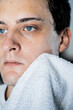 © Olga Kozicka/Stocksy - Cleaning Face With Towel After Men's Skin Care Routine
