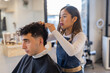 © Javier Pardina/Stocksy - Hairdresser with a client