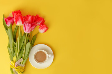 Wall Mural - Beautiful spring breakfast on Mothers or Womans International day 8 march, 14 february. Bouquet of pink tulips, coffee cup on bright yellow table. Flat lay, banner for site, seasonal flyer