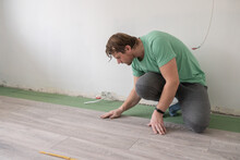 Man Lays Laminate Flooring