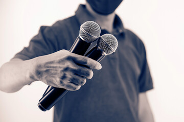 Microphone public speaking background, Close up hand holding microphone for speaker speech presentation stage performance and declaration publication or interview.