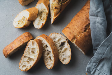 Wall Mural - Freshly baked homemade bread with crispy crust on gray background