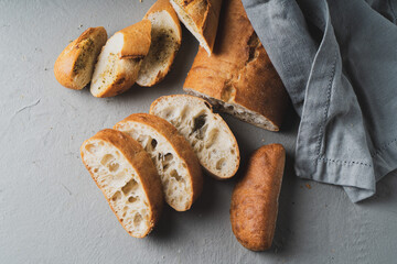 Wall Mural - Freshly baked homemade bread with crispy crust on gray background