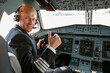© Kostiantyn - Male pilot sitting in airplane cockpit and giving thumbs up