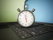 Chronometer standing on laptop keyboard. 3D illustration