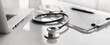 Doctor office desk panoramic banner, workplace of physician therapist with stethoscope in focus closeup, Health care, medicine, medical insurance concept.