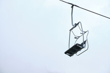 Empty Chairlift With A Cloudy Sky Background