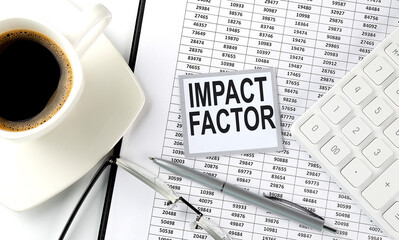 Poster - IMPACT FACTOR text on sticky on the chart with coffee,pen and calculator