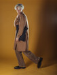 © qunica.com - Portrait of a smart young man standing against yellow backgroun