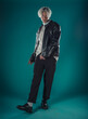 © qunica.com - Male beauty concept. Portrait of fashionable young man with stylish haircut wearing trendy glasses and sweater, posing over gray background. Perfect hair & skin. Hipster style. Copy-space. Studio shot