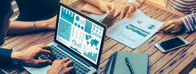 Business data dashboard analysis by ingenious computer software . Investment application display business sales and profit on the computer screen and advise marketing planning decision .