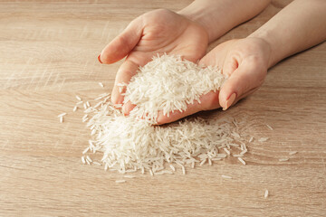 Canvas Print - raw rice in hands