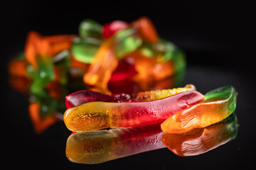 Sticker - Juicy colorful jelly worms sweets. Gummy candies. Snakes. On black backgriund