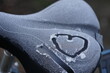 a bicycle saddle covered with ice