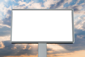 Wall Mural - front view: blank white billboard against warm sunset sky. sun beams shining through dramatic clouds
