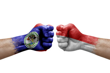 Two hands punch to each others on white background. Country flags painted fists, conflict crisis concept between belize and indonesia