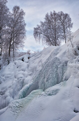 Fototapete - Photo of frozen waterfall on river Pescherka in winter. Siberia, Russia
