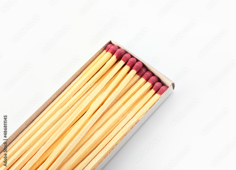 Matchbox with fireplace matches on white background, closeup