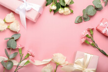 Frame Made Of Gift Boxes And Flowers On Color Background, Closeup