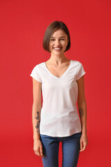 Wall Mural - Beautiful young woman in stylish t-shirt on color background