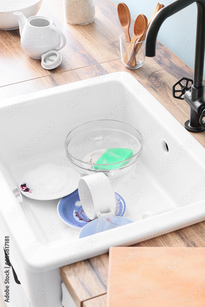 Dirty dishes in ceramic sink