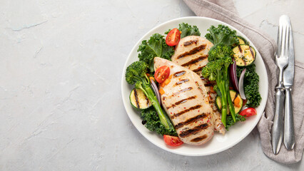 Wall Mural - Grilled chicken with vegetables on light background.