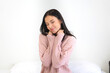 © Art_Photo - Smiling of cheerful beautiful pretty woman clean fresh healthy white skin posing in warm knitted pink clothes.Girl felling relaxing and enjoy time on the bed at home