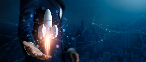 startup business concept, businessman control white rocket is launching and soar flying out from han