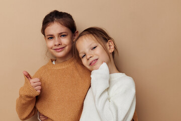 two funny little girls in sweaters posing childhood