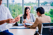 © Chanyanuch - Asian Young teamwork meeting and discuss at the meeting room in office for smooth business ,colleagues,partnership, goal achievement concept.