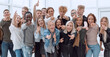 © ASDF - large group of happy young people showing their success