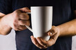 © Марина Трунева - Man holding a big white cup. Soft selective focus.