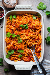 Wall Mural - Baked spaghetti pasta with sausages in tomato sauce in oven dish.