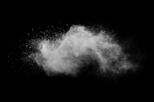 Explosion Of White Powder Isolated On Black Background. Abstract Colored Background. Holi Festival.