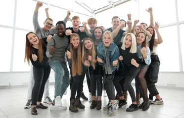 Wall Mural - in full growth. lots of happy young people standing together