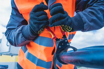 Two electrician builder workers installing high-voltage cable