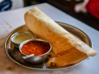 Wall Mural - A closeup shot of a Masala Dosa with sambar and chutney