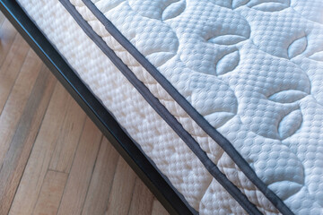 Mattress on a bed close up. Home bedroom interior detail, high angle view .