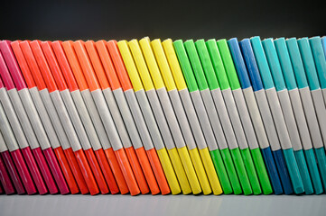 Colorful sealed notebook on shelf in stationery shop. Business and education supply