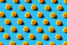 Yellow Rubber Duck Toys Pattern On Seamless Blue Background.