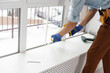 © Angelov - A worker in gloves checks the lock in a new plastic door