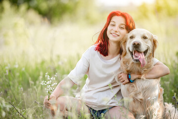 Teen girl with golden retriever dog