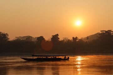 Beautiful red and orange sunrise at Rio Madre de Dios near Puerto Maldonado in the Tambopata National Park in the Amazonas region (Peru, South America)