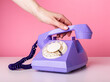© valiantsin - Hand holding retro phone handset, receiver closeup on pink background. Vintage style. High quality photo