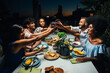© oneinchpunch - Group of friends having fun on the rooftop of a beautiful penthouse. Multiethnic group of people eating outdoor on the balcony and celebrate