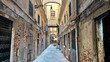 Woman walks through the narrow street of venice