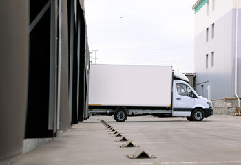 Sticker - Truck near loading dock of warehouse outdoors. Logistics center